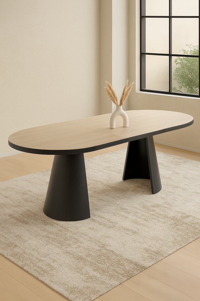 Modern oval dining table with black legs in a room with a window and rug.